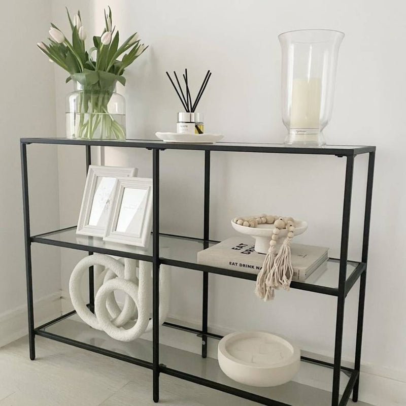 Chic and versatile three-tier black console table, ideal for organising and enhancing any home or office setting.
