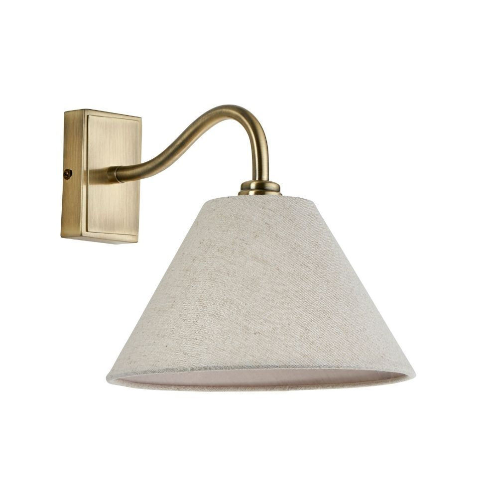 Antique brass wall light with natural linen fabric shade isolated on white background showing classic design.