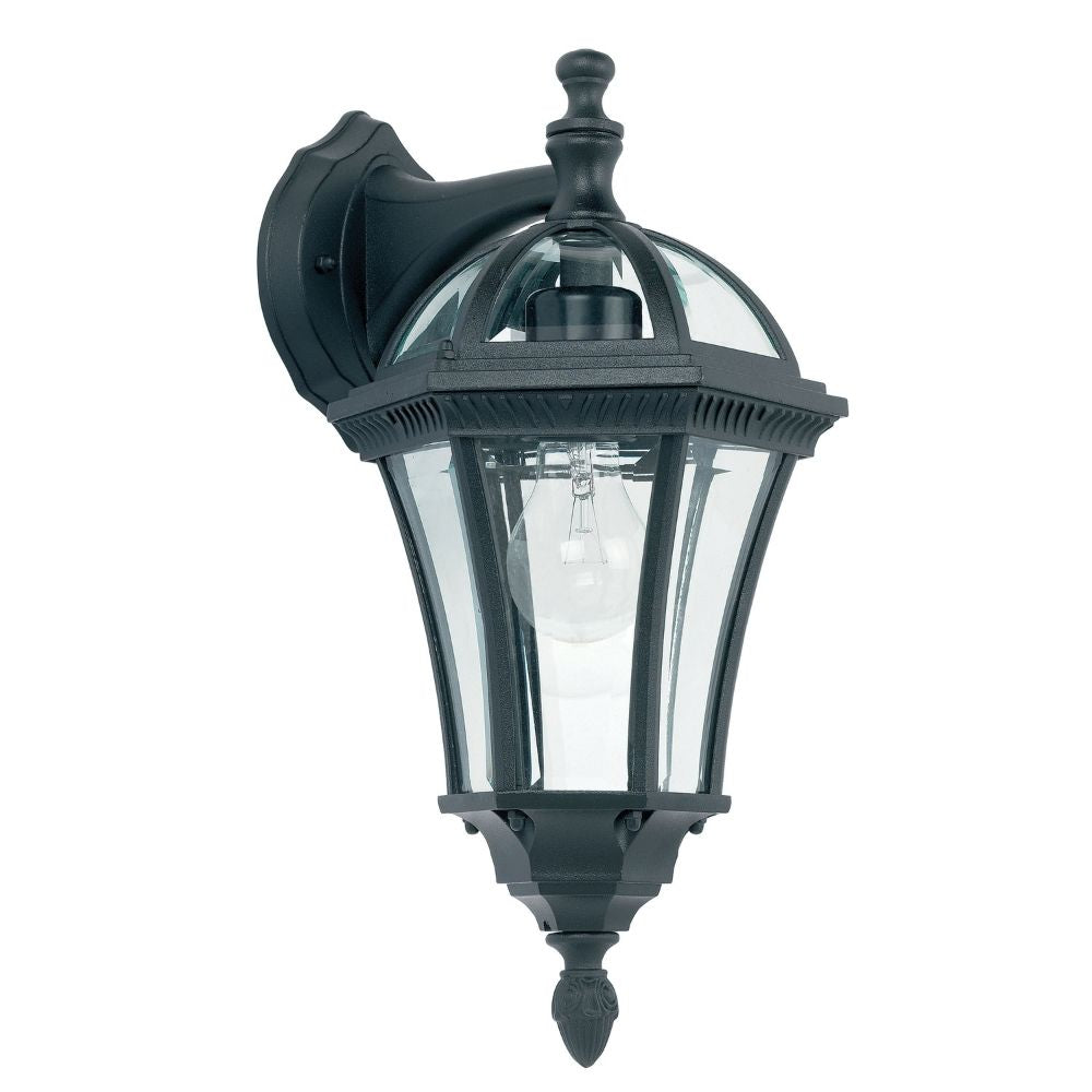Classic black wall lantern light with curved glass panels and decorative finial isolated on plain background.
