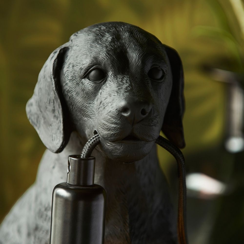 Close-up of black Labrador resin lamp showing detailed texture and cable held in mouth, highlighting realistic sculpted design and craftsmanship.