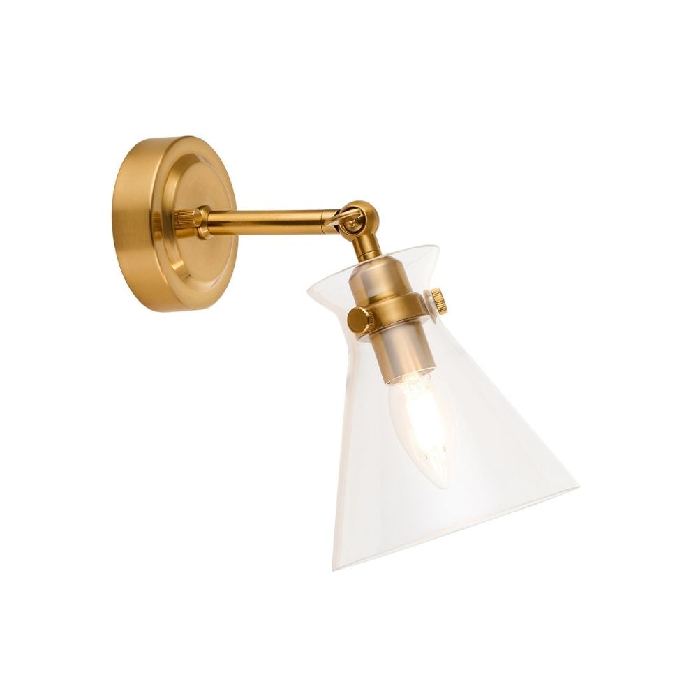 Modern brass wall light featuring adjustable arm and clear glass cone shade displayed on a plain background.