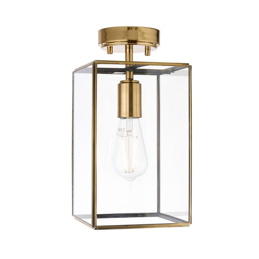 Front view of a brass and glass lantern style ceiling light with exposed bulb shown against a plain light background.