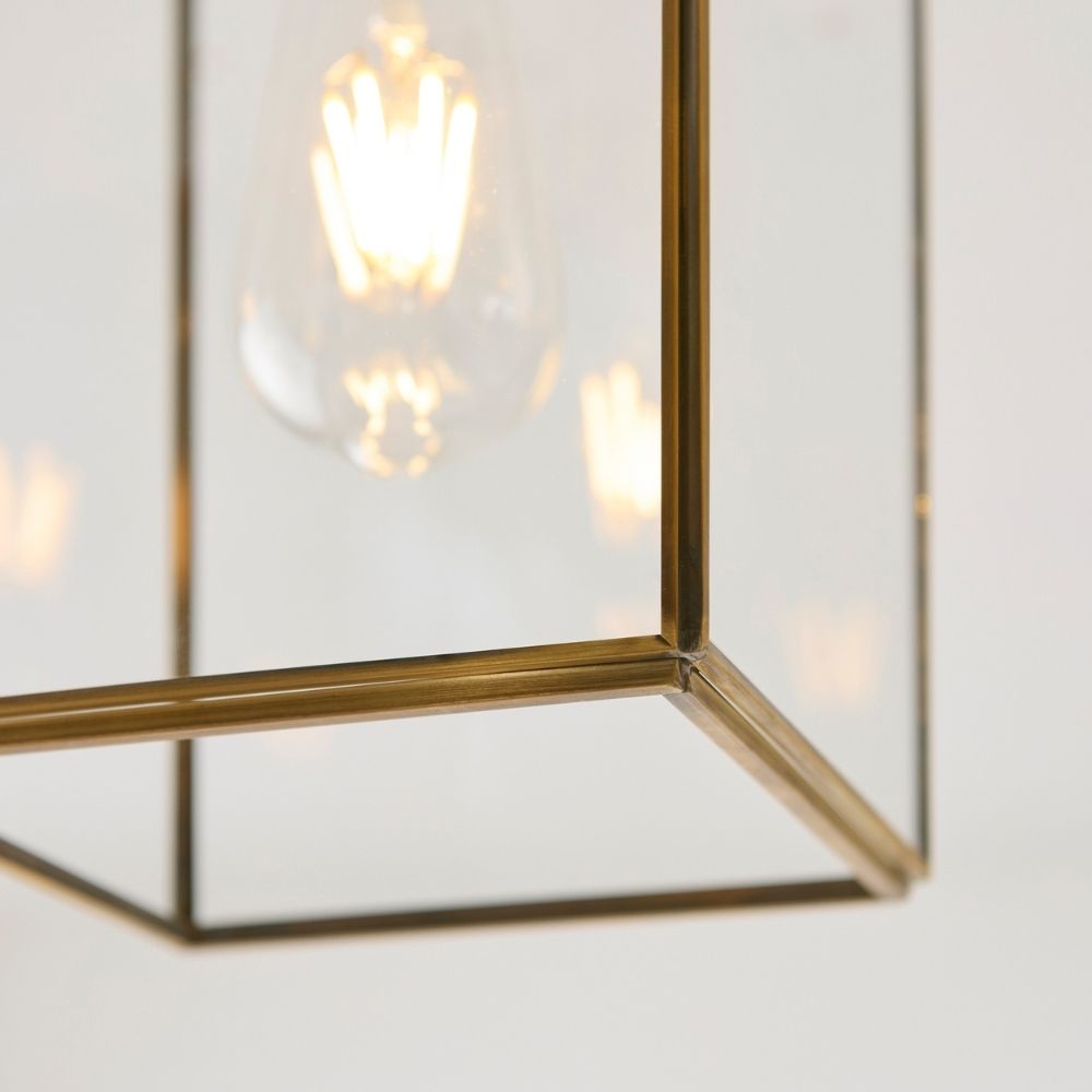 Close-up of brass ceiling light fitting showing bulb holder and mounting plate with polished metal finish.