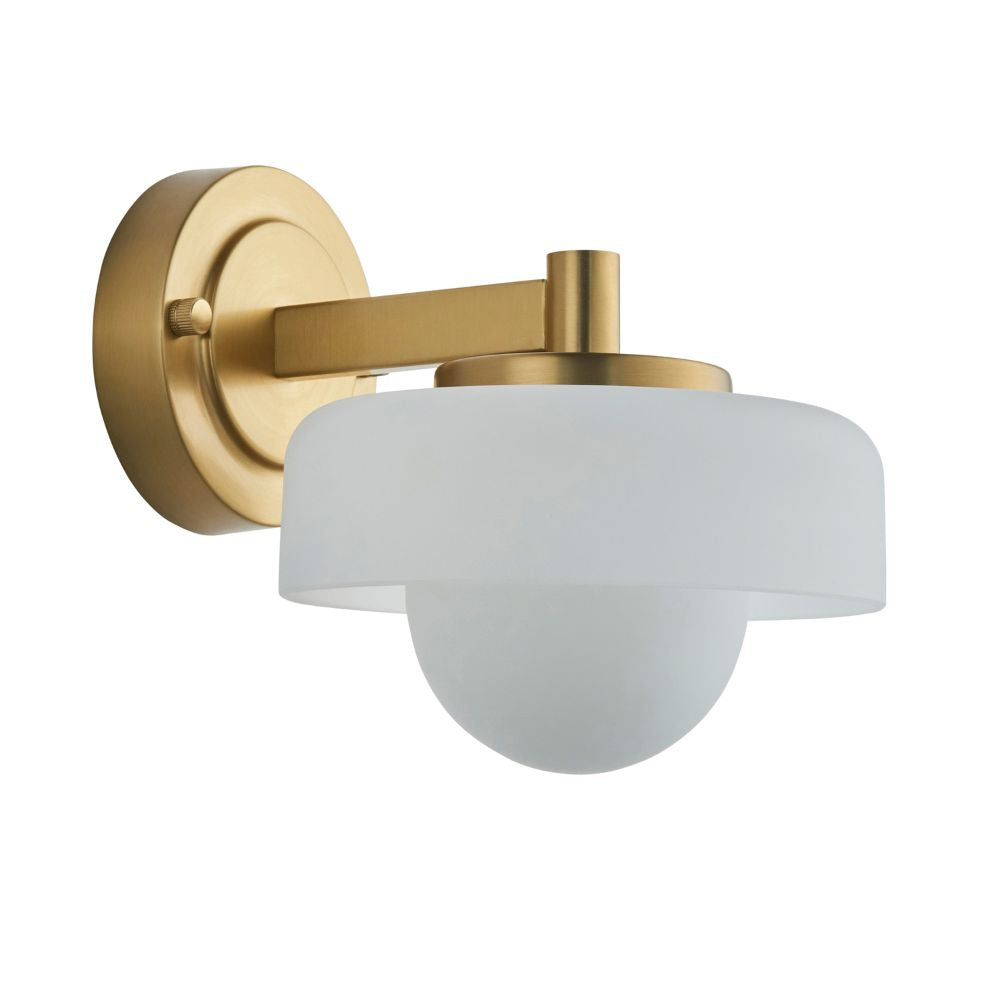 Modern brass wall light with an opal glass shade and contemporary round design on a plain background.