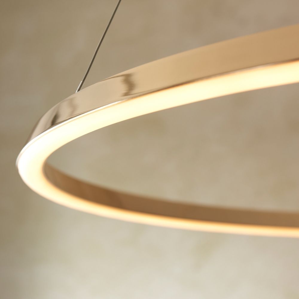 Close up of gold LED ring pendant light showing smooth metallic finish and integrated warm light strip.