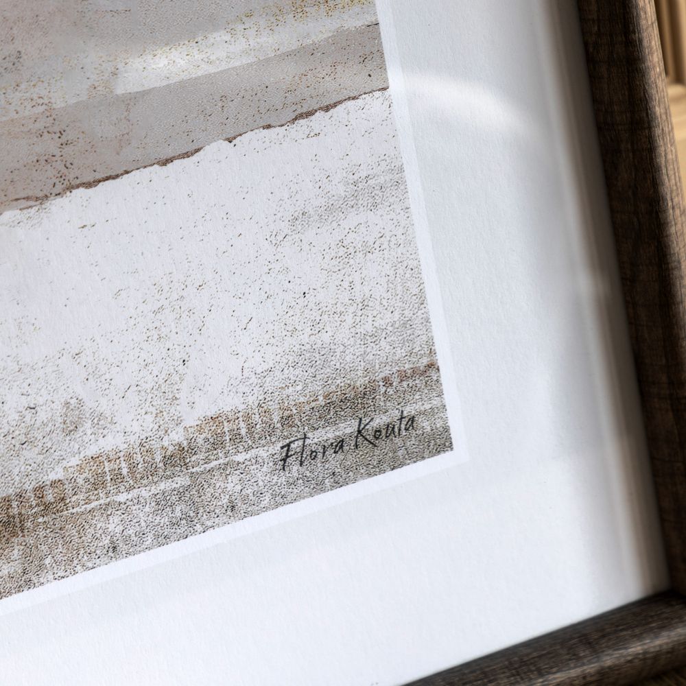 Close-up detail of neutral abstract framed print featuring textured beige and grey layers with artist signature detail.