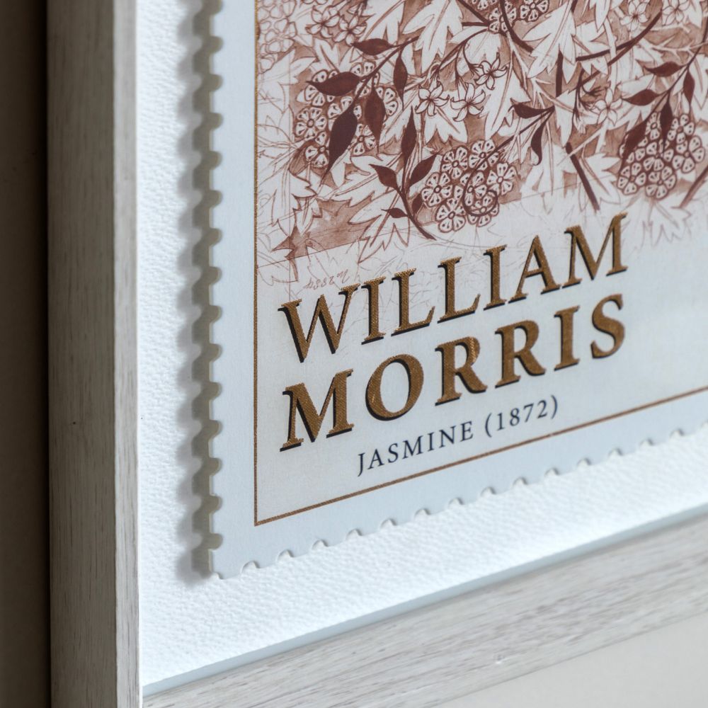 Close-up detail of William Morris Jasmine print with gold foil typography, floral illustration and decorative stamp-edge border.