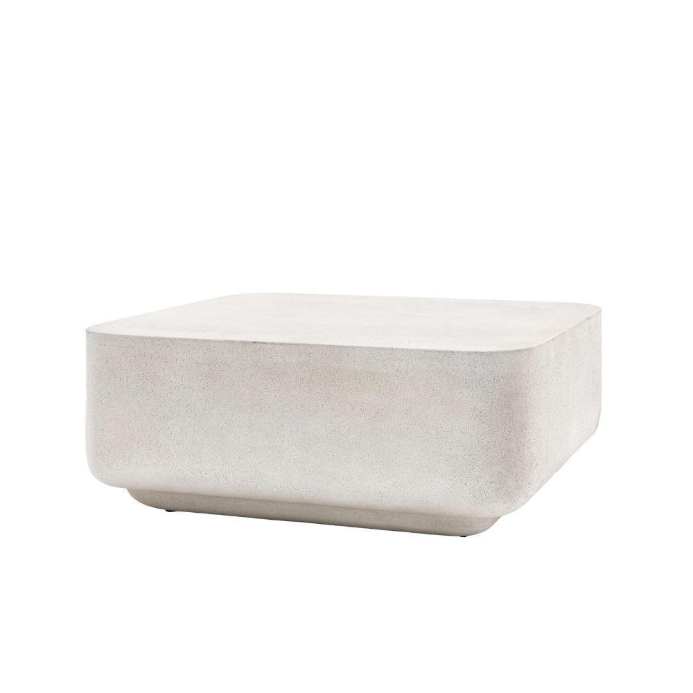 Minimalist round coffee table with concrete effect finish and smooth curved edges on a plain background.