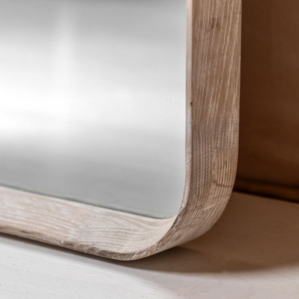 Detailed corner close-up of a pale oak full length mirror frame with rounded edges and visible natural wood texture.