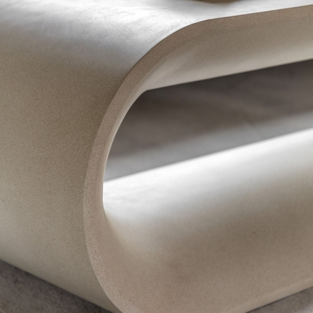 Close up of curved arch detail showing smooth rounded edges and seamless construction of the concrete coffee table.