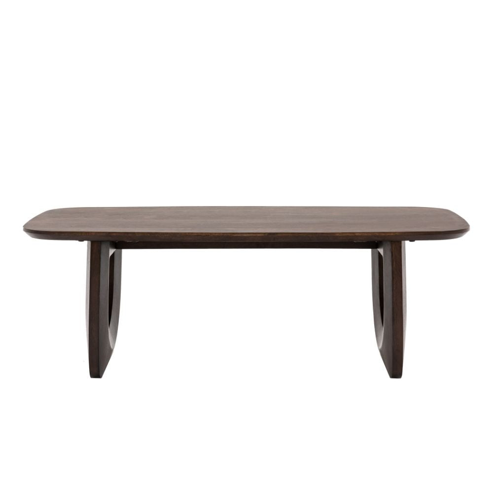 Rectangular coffee table in dark mango wood featuring softly rounded corners and distinctive sculptural U-shaped legs on a plain background.