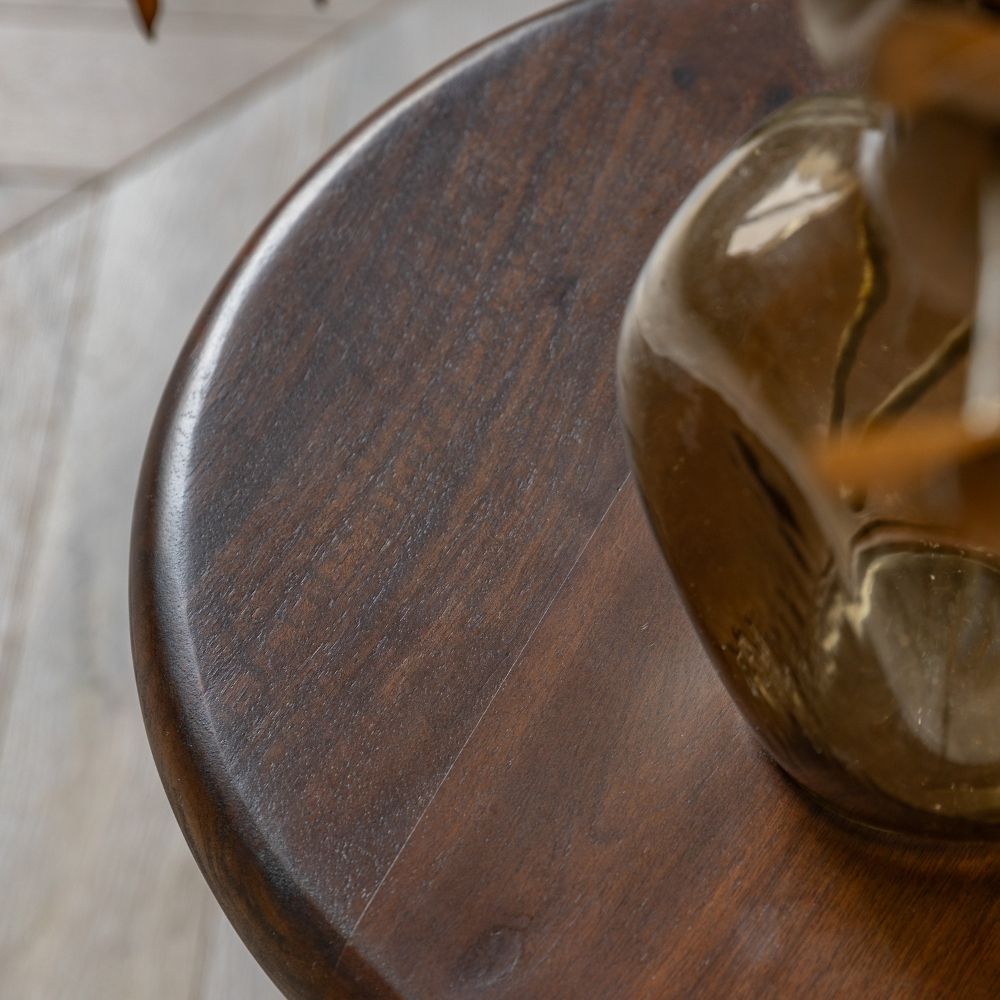 Close up of dark mango wood tabletop highlighting natural grain patterns and smooth polished finish.