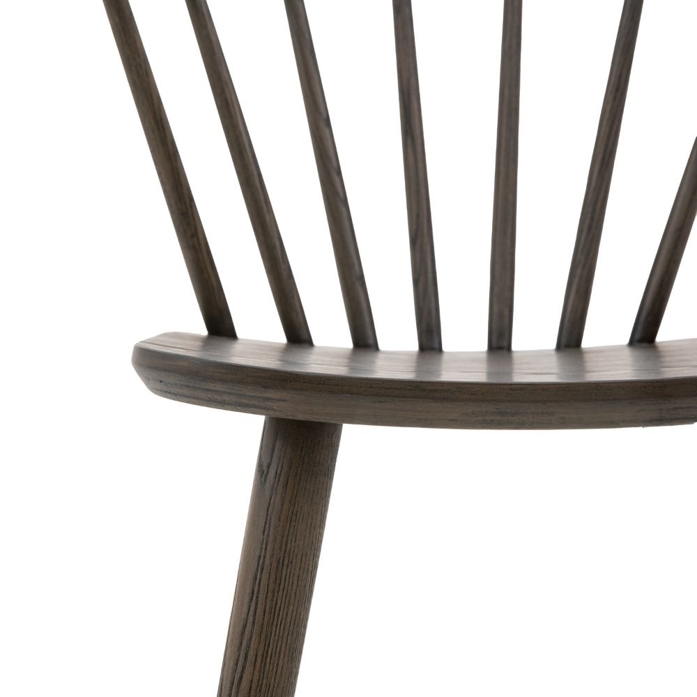 Detailed close-up of dark oak bar stool seat and spindle back connection highlighting smooth finish and wood texture.