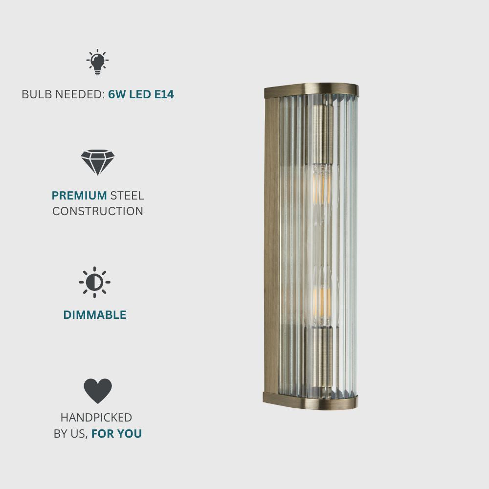 Dimmable dual-bulb brass wall light with ribbed glass surround and a sleek modern design for hallways or living spaces.