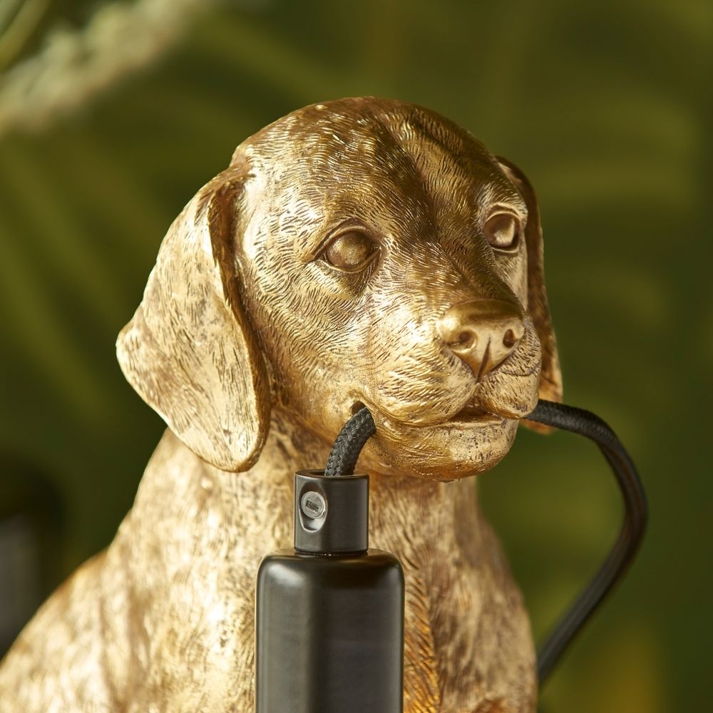 Close-up of gold labrador resin lamp showing detailed fur texture and cable held in mouth, highlighting craftsmanship and realistic sculpted design.