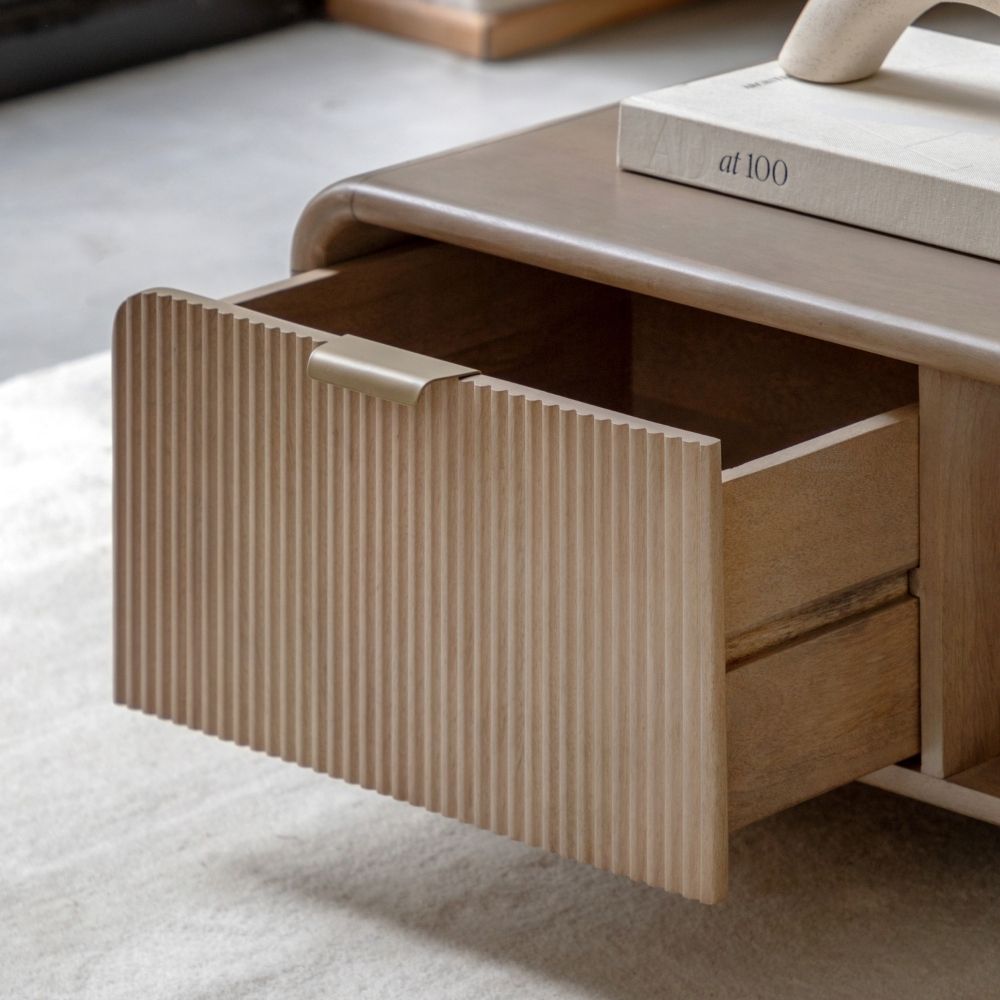 Close up of fluted drawer front with integrated handle showing textured wood detailing and smooth sliding mechanism.
