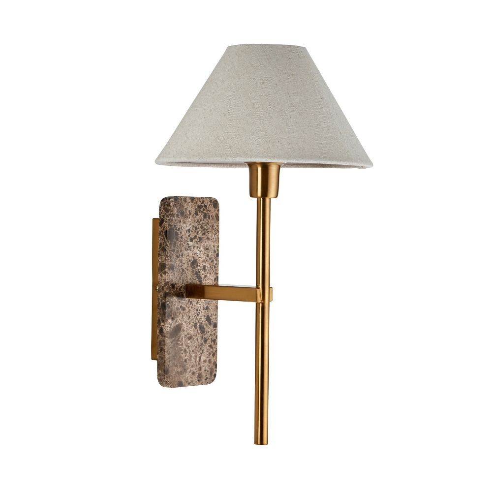 Elegant wall sconce with textured brown marble backplate, slim brass stem, and tapered linen lampshade on a white background.