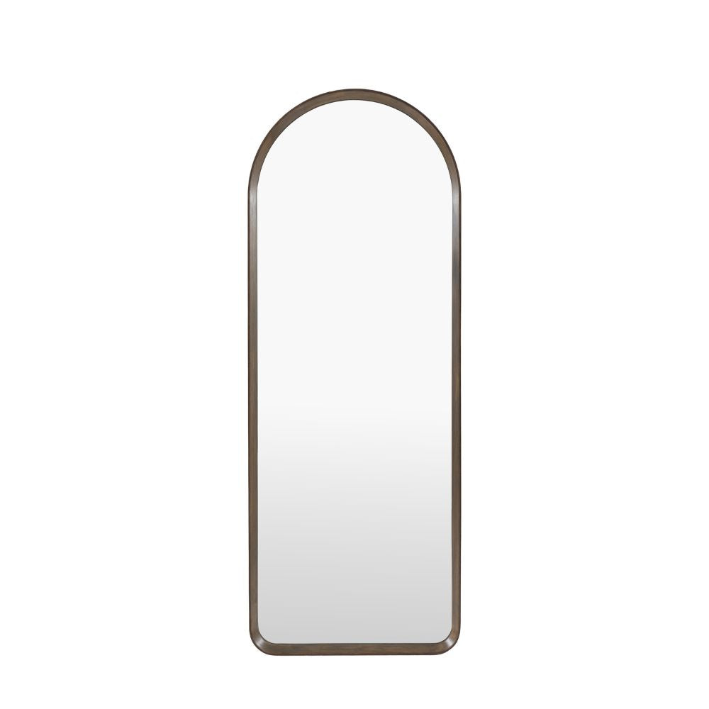 Minimalist arched full length mirror with a slim dark wood frame isolated on a light grey background.