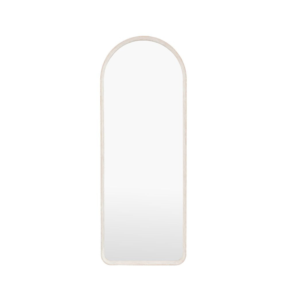 Minimalist arched full length mirror with a pale oak wooden frame isolated on a light grey background.