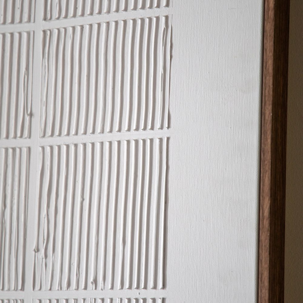 Detailed close-up of modern textured wall art with vertical linear patterns and minimalist neutral styling.