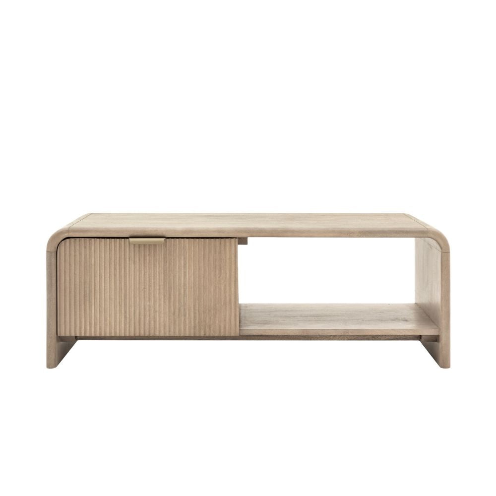 Minimal mango wood coffee table featuring a fluted drawer front, integrated handle and open shelf on a clean background.