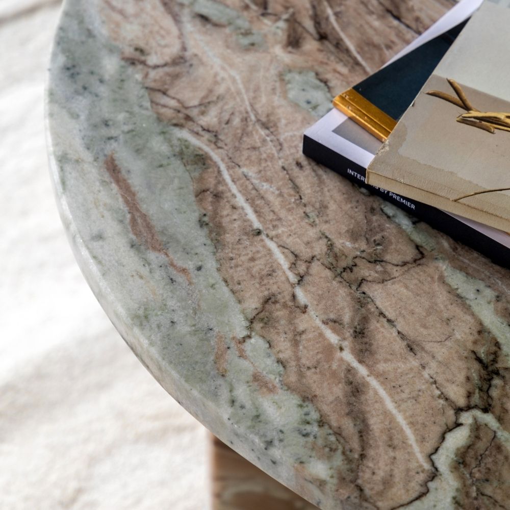 Detailed view of natural marble tabletop showing organic veining patterns and smooth rounded edge finish.