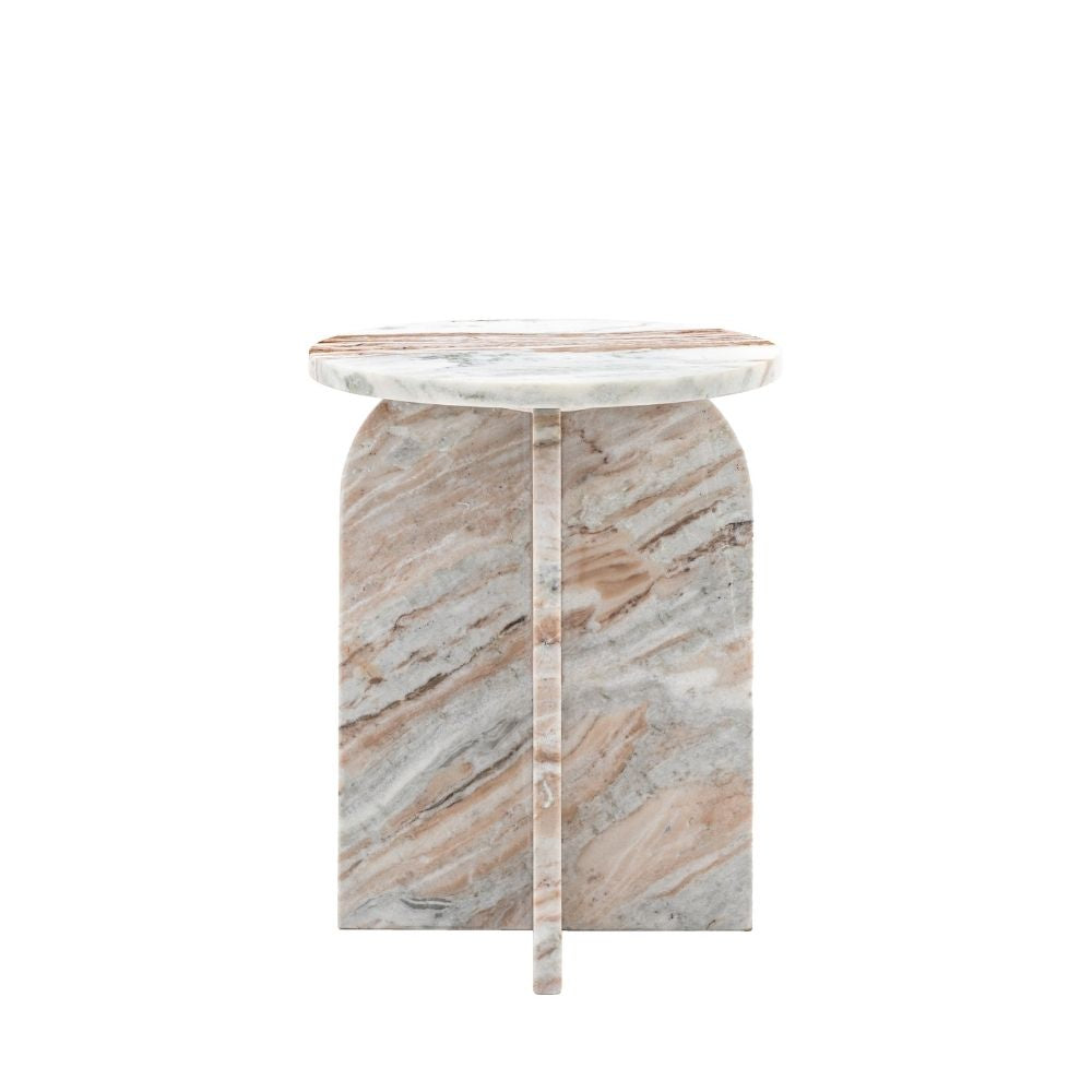 Natural marble side table with round top and curved sculptural base featuring soft beige and grey veining on a white background.