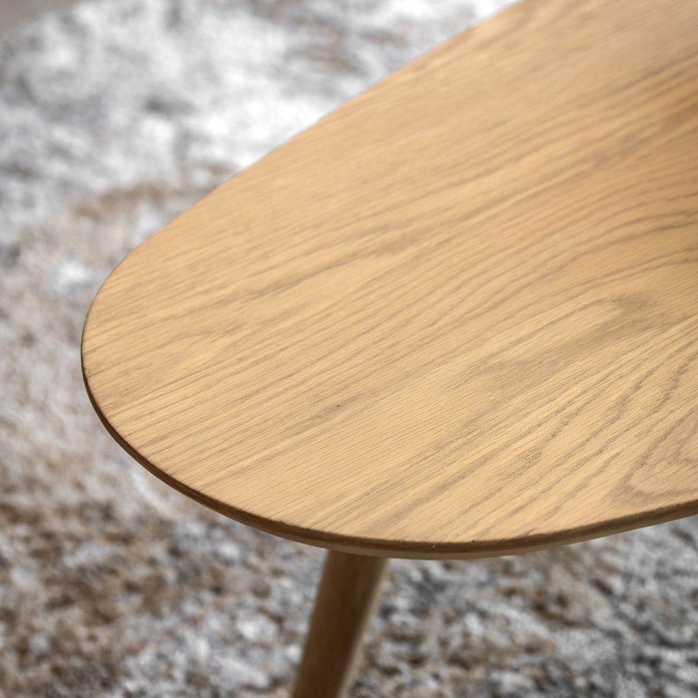 Close up of natural oak coffee table top showing smooth rounded edge and fine wood grain texture.
