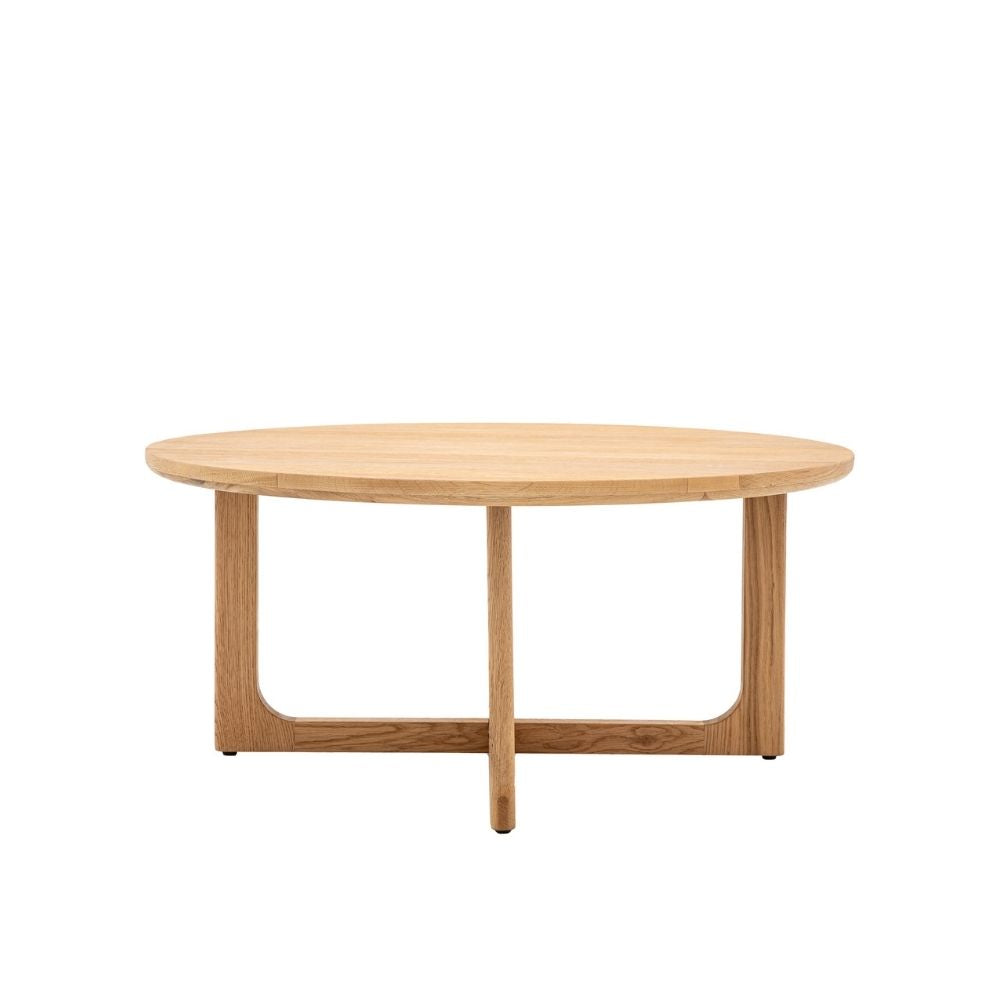 Round coffee table in natural oak with smooth curved frame and minimalist design on a neutral background.