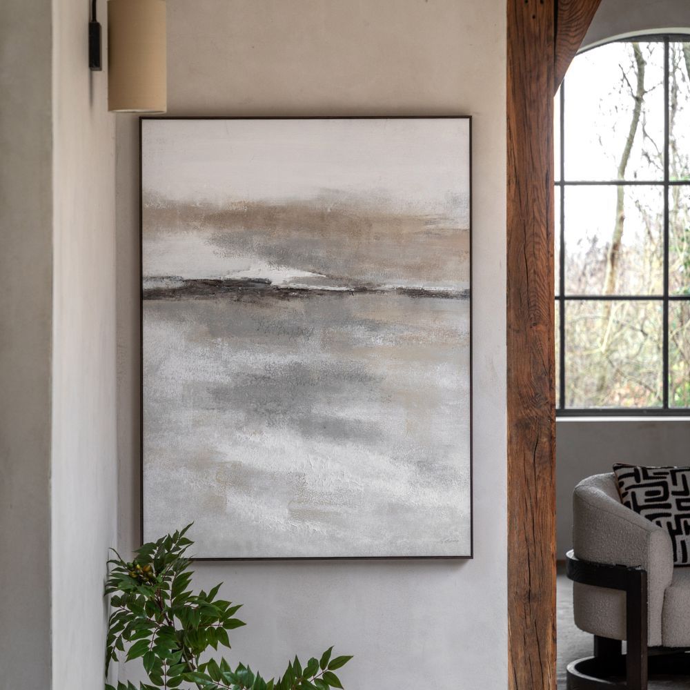 Neutral abstract landscape canvas wall art with soft beige, grey and white tones in a slim dark frame.