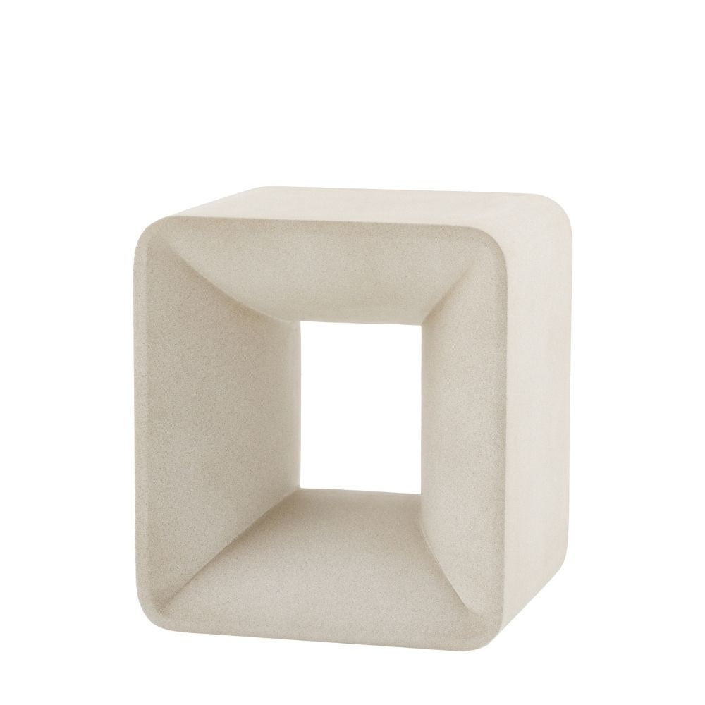 Minimalist neutral cube side table made from glass fibre reinforced concrete with hollow centre and smooth curved edges.