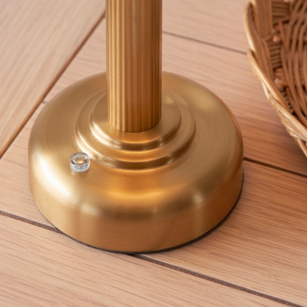 Close-up of rechargeable brass touch dimmer table lamp base showing brushed finish, touch control button, and sturdy design on wooden surface.