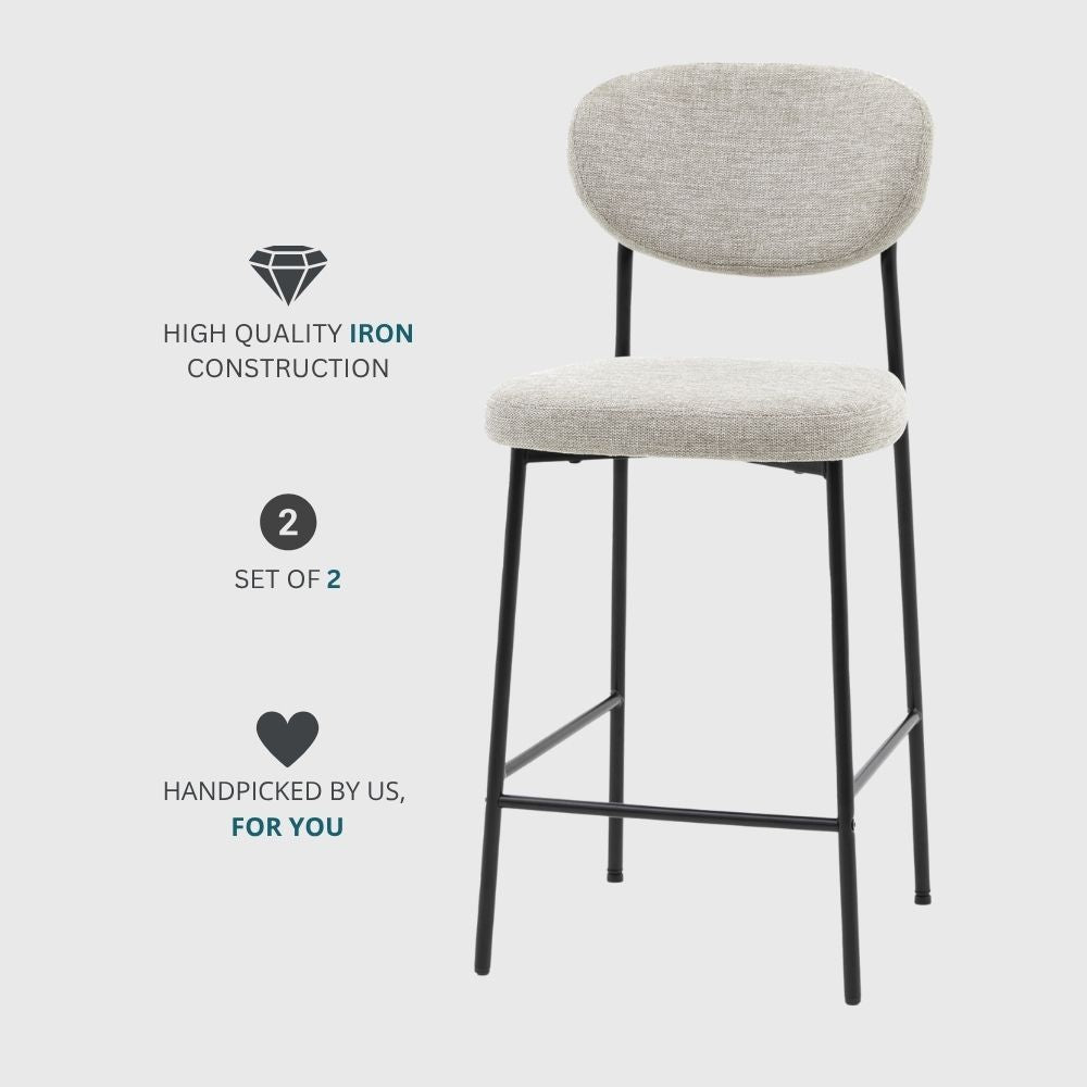 Promotional image of a set of two natural fabric upholstered bar stools with black metal legs and iron construction on a light background.