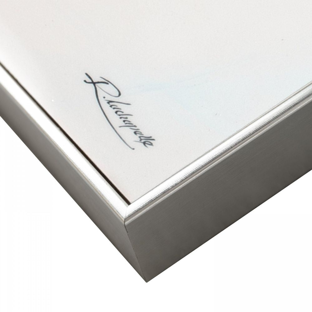 Close-up detail of brushed silver picture frame corner surrounding modern skier wall art print.