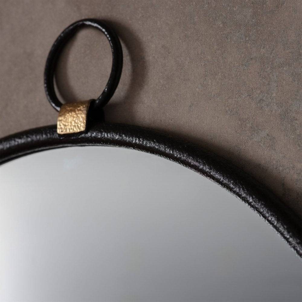 Elegant and simplistic round mirror with a black frame, ideal for creating a clean and sophisticated look.
