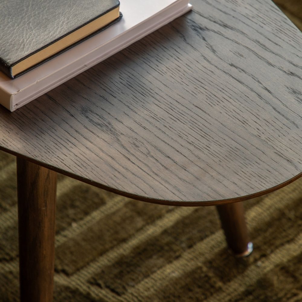 Close up of smoked oak coffee table surface showing rich wood grain texture and smooth rounded edge detail.