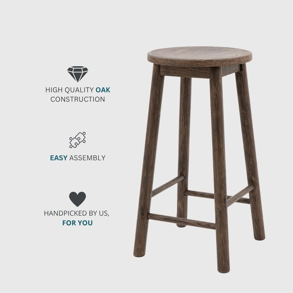 Smoked oak wooden bar stool with round seat and four legs displayed alongside icons highlighting high quality oak construction, easy assembly and handpicked design.