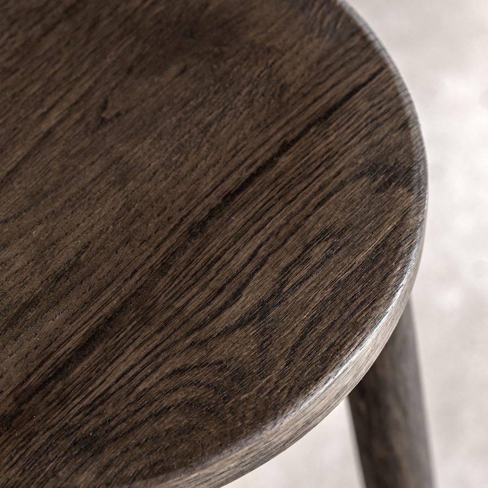Detailed close-up of a smoked oak wooden bar stool seat highlighting the rich wood grain and smooth finish.