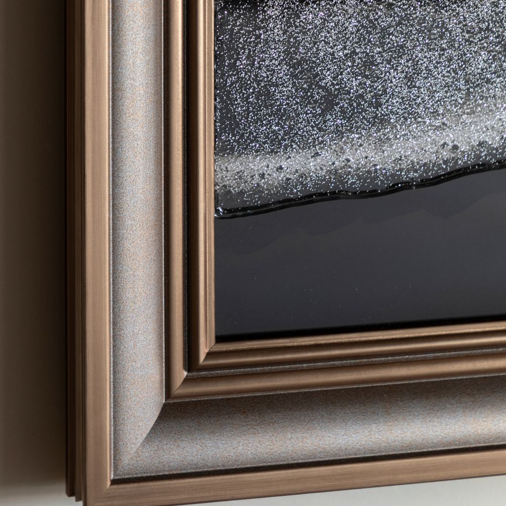 Detailed close-up of textured monochrome seascape artwork with sparkling shoreline accents and dark ocean tones.