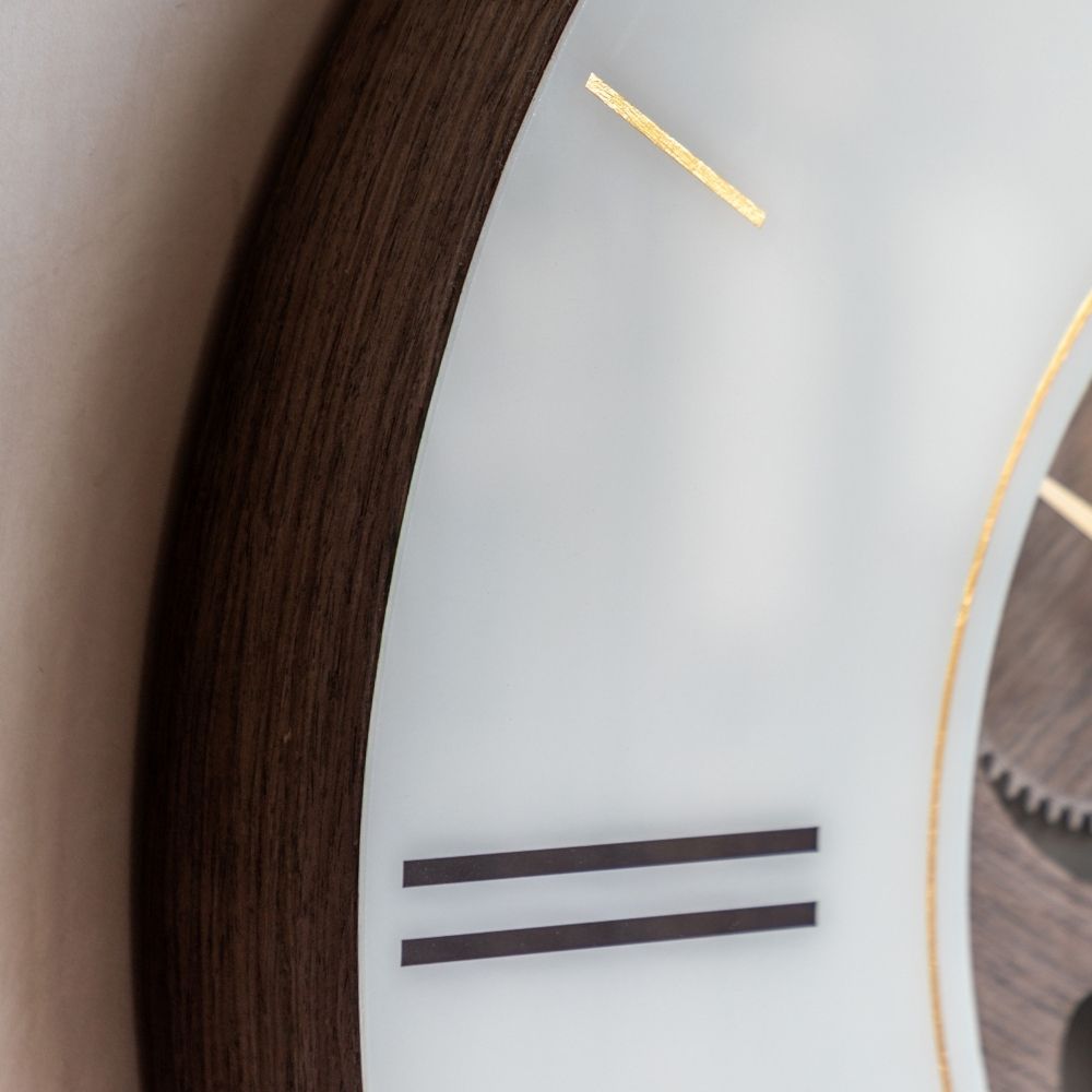 Close-up of the Thomas Kent Cogger dark walnut wall clock showing the deep wood-effect outer frame, cream dial and gold detailing