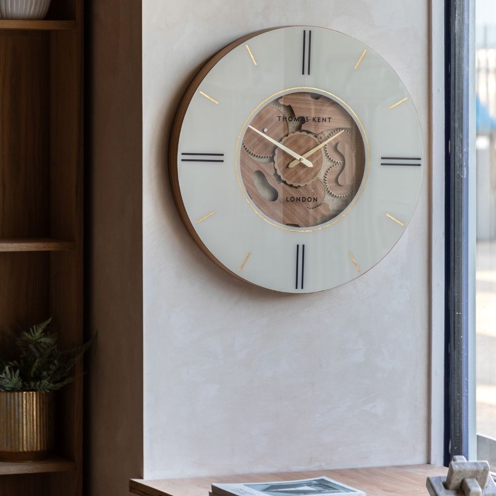 Thomas Kent Cogger oak 60cm cog wall clock with cream dial, decorative wooden gears and gold detailing styled in a modern interior