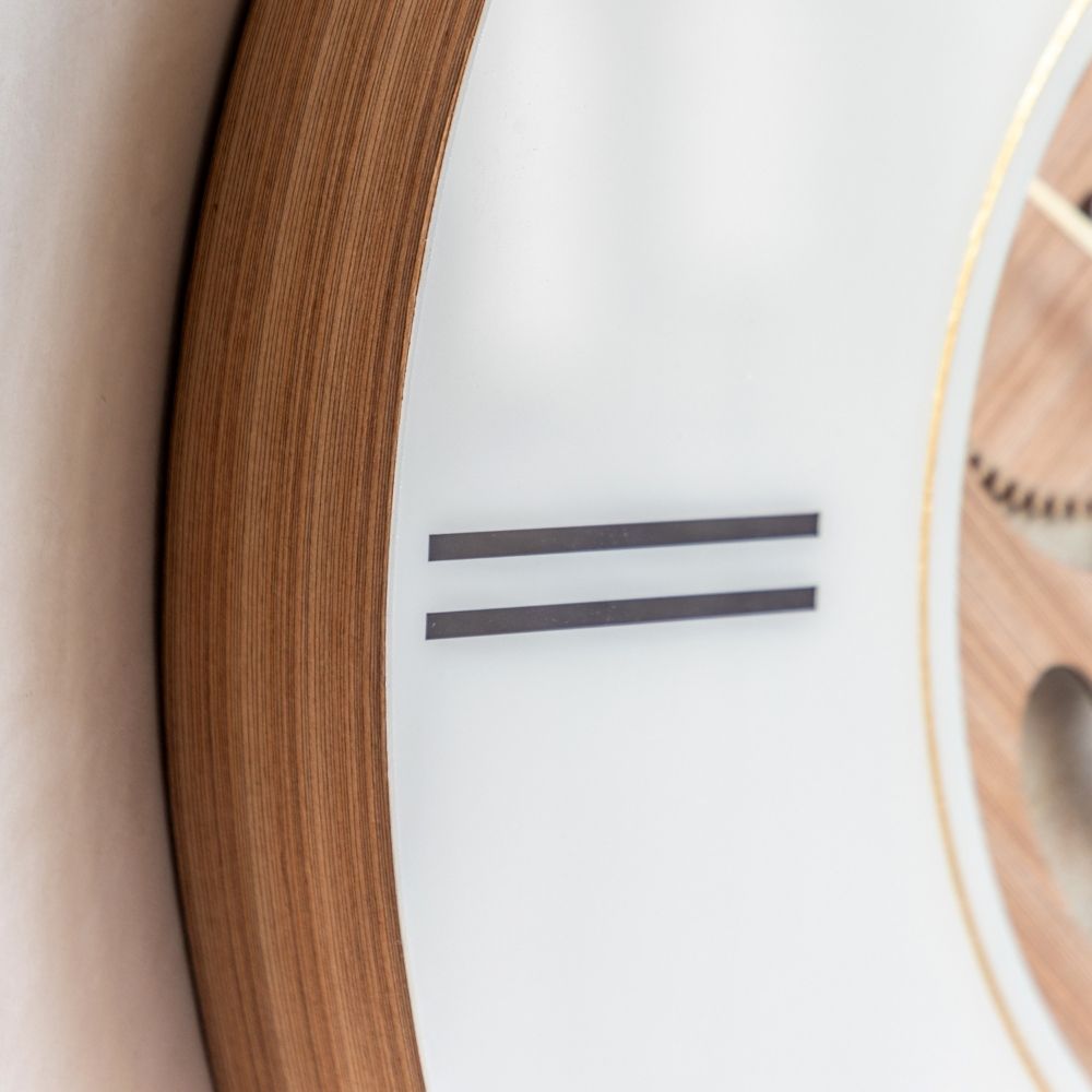 Close-up of the Thomas Kent Cogger oak wall clock showing its warm wood-effect frame, cream dial and minimalist hour markers