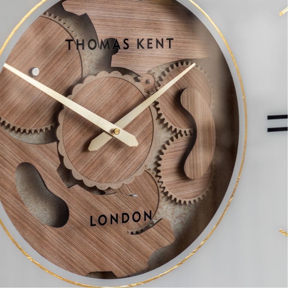 Close-up of the Thomas Kent Cogger oak wall clock showing the decorative wooden gears, gold hands and exposed cog centre