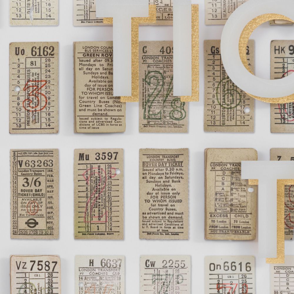 Close-up of vintage transport ticket wall art featuring antique ticket designs and layered modern typography elements.