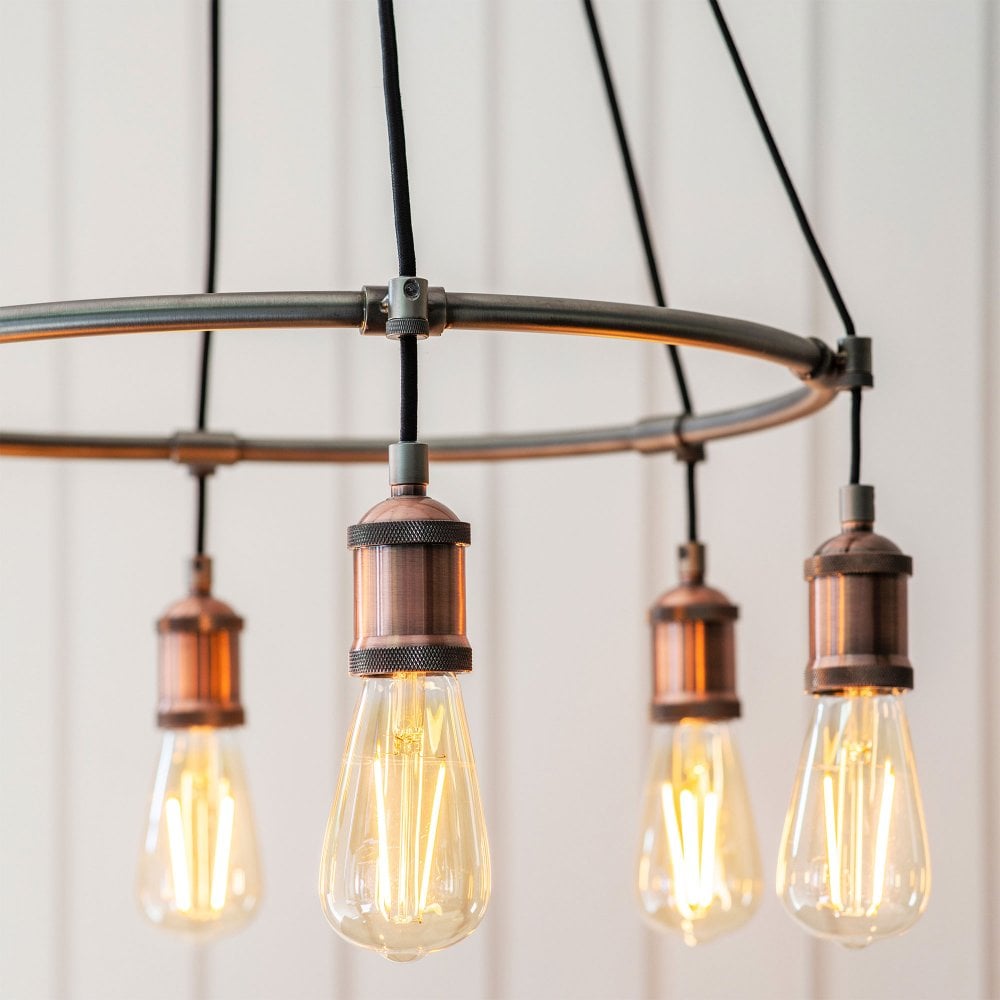 Stylish industrial-inspired chandelier with an aged copper finish, ideal for loft-style or rustic settings.
