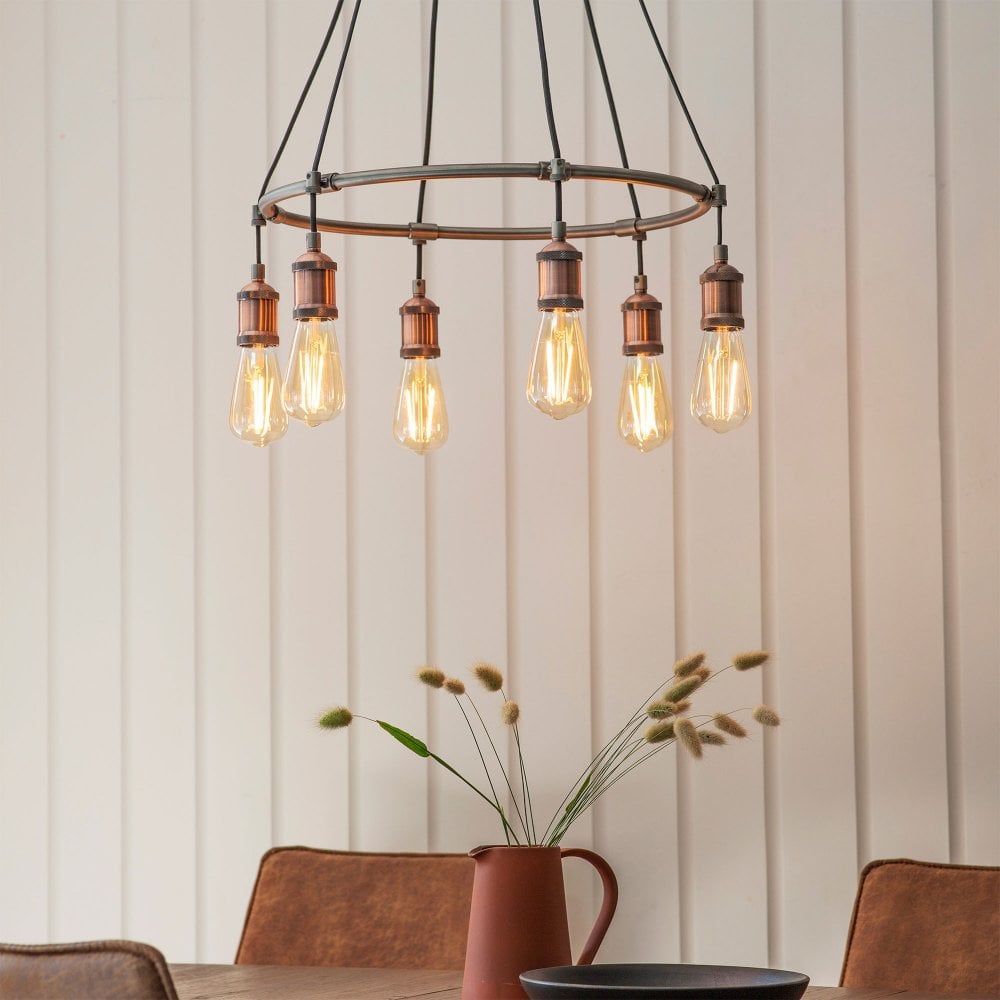 Striking industrial-style chandelier in aged copper, perfect for adding a vintage touch to any space.
