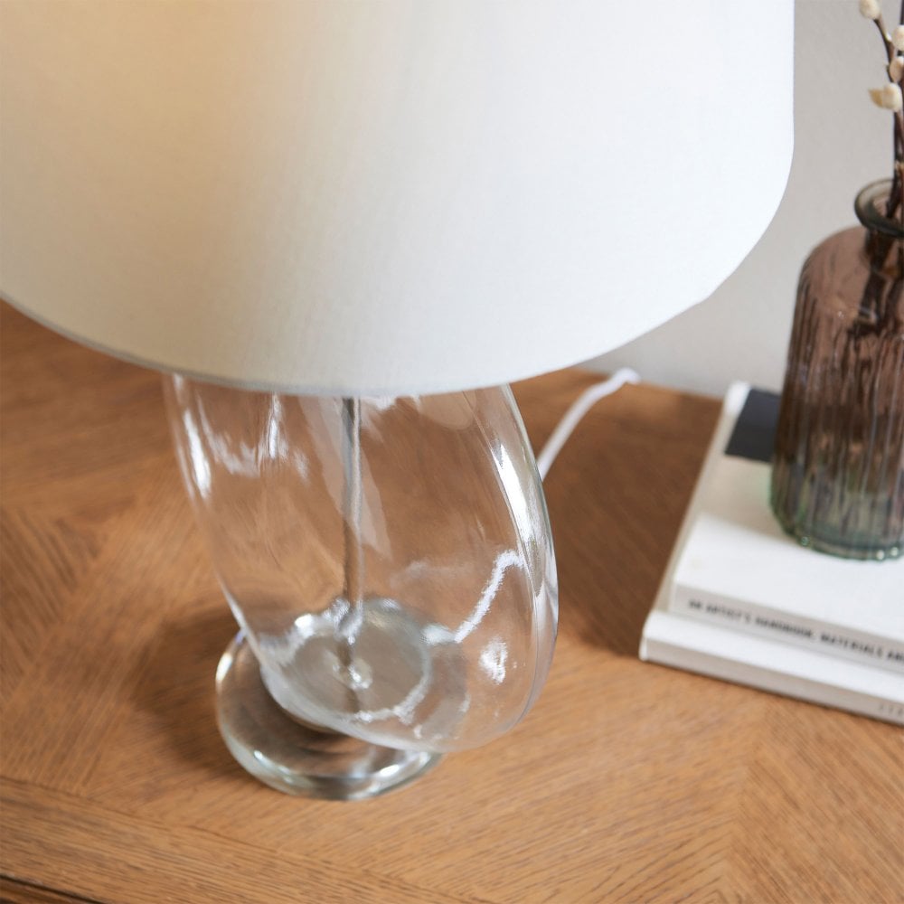 Beautifully crafted classic glass lamp with a soft white linen shade, offering a warm and inviting glow.
