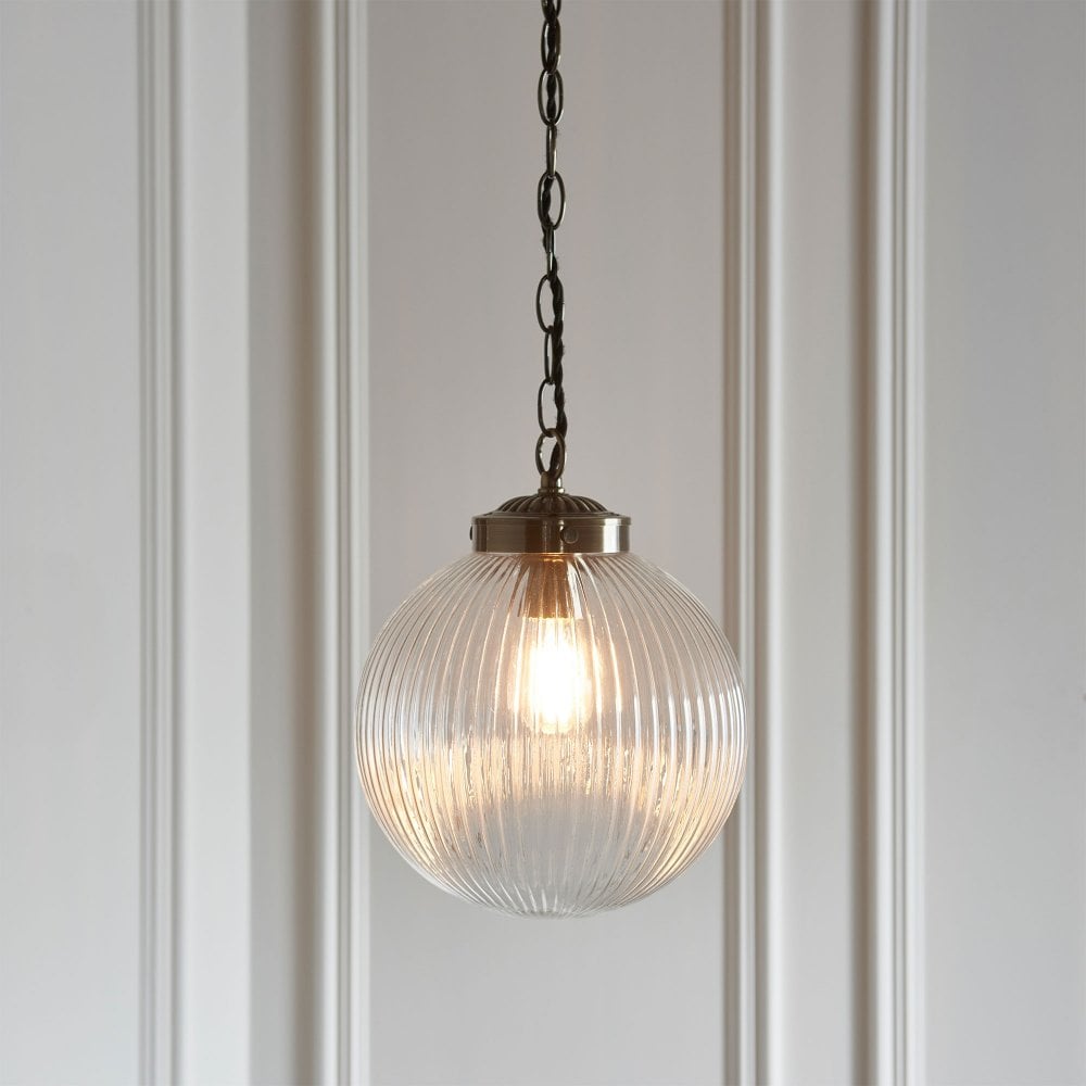 Elegant traditional ribbed pendant light in antique brass, perfect for adding vintage charm to any space.
